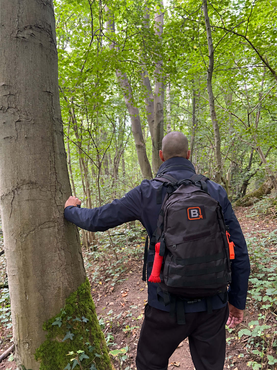 The Plan B founder wearing the Core Ready Bag in woodland