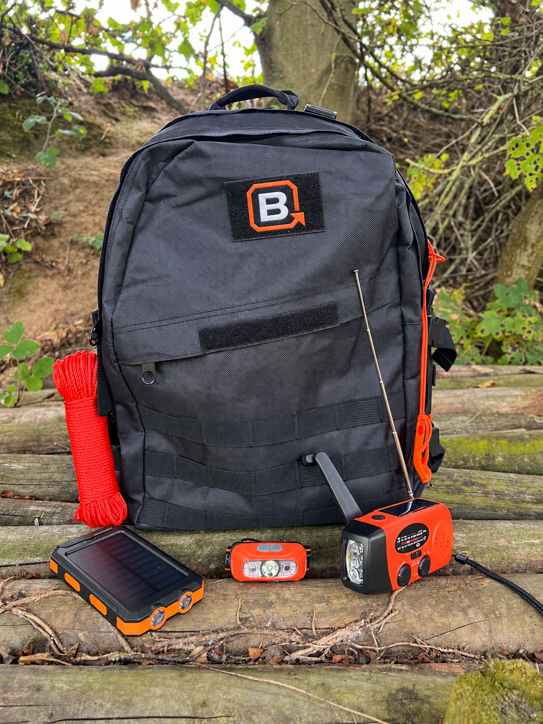 Power bank, radio and head torch with the Plan B bag outdoors